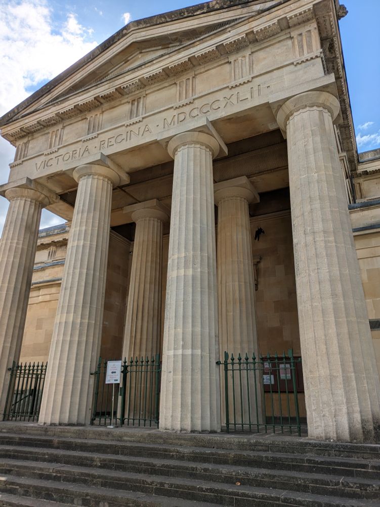 Y Gaer Museum Art Gallery & Library, a neoclassical front. Above the pillars it says "Victoria Regina MDCCCXLII"