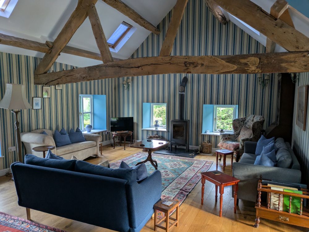 A big living room with beams crossing the ceiling