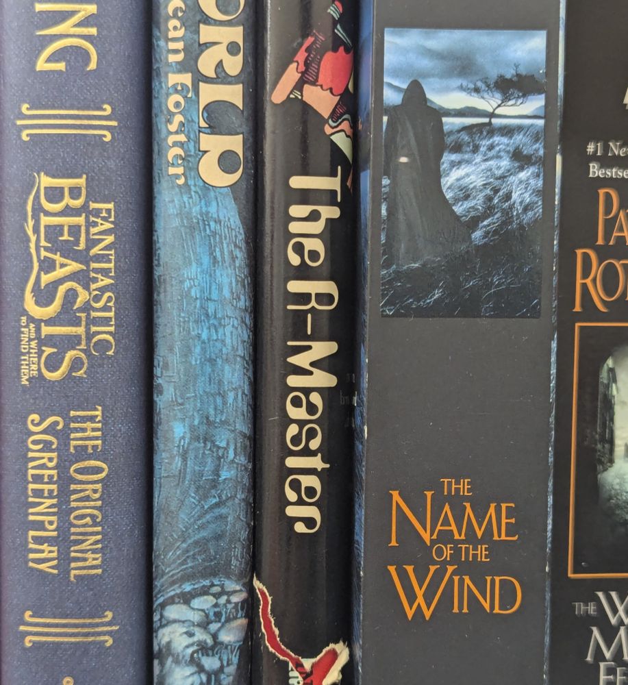 Science fiction and fantasy books, the middle of which has the title "The R-Master".