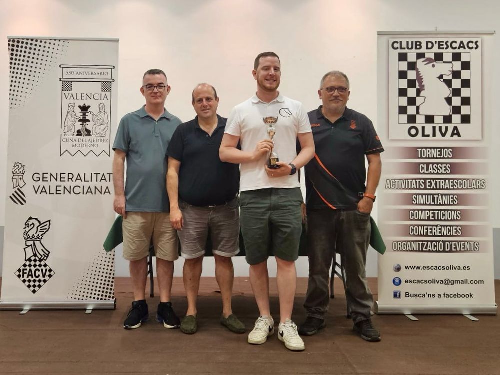 Me holding the trophy with the tournament organisers 