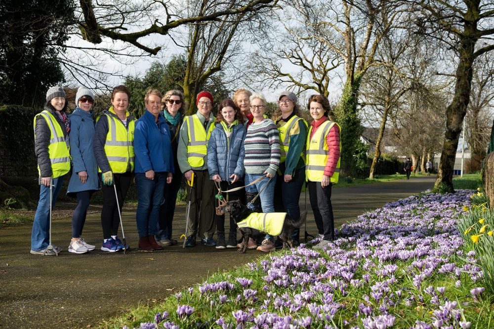 Women of tidy towns stand beside a display of crocus 