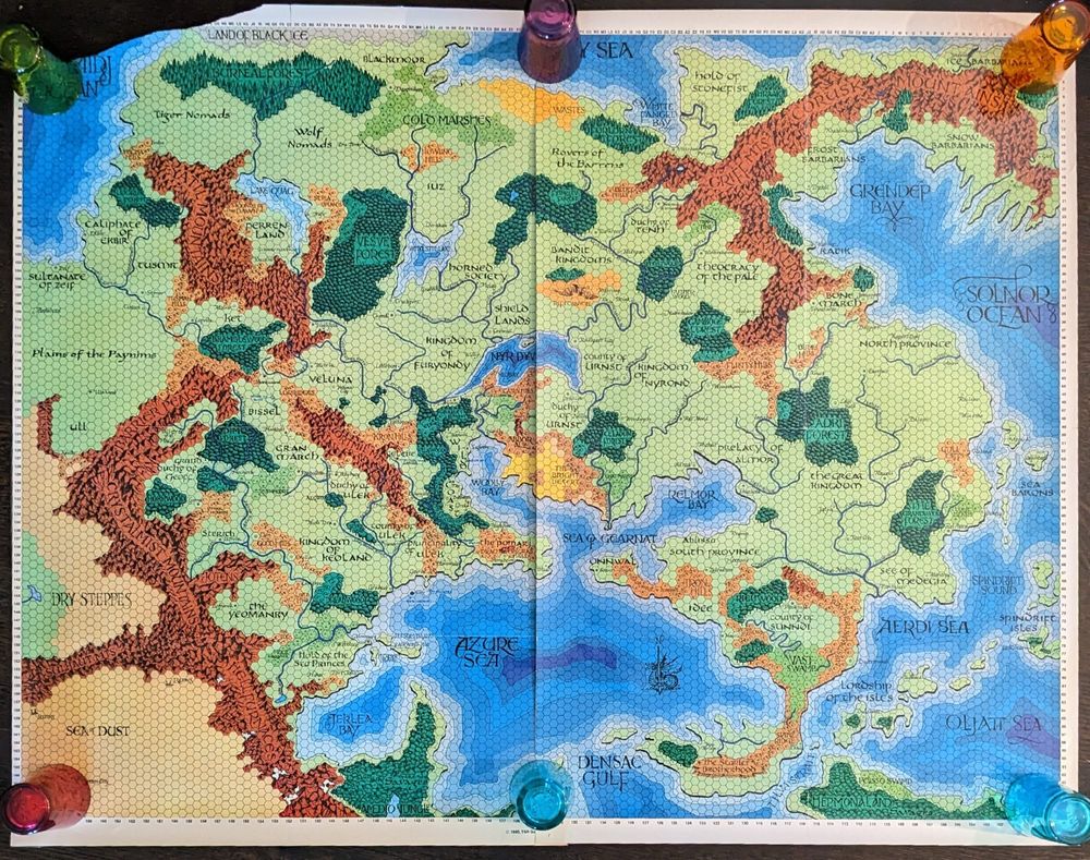 2 poster Map of the Eastern Portion of the Oerik continent from The World of Greyhawk folio edition (1980, TSR Games) 9025. The map is missing its top left corner. Colored glasses (6 of them) hold down the 2 posters of the map.