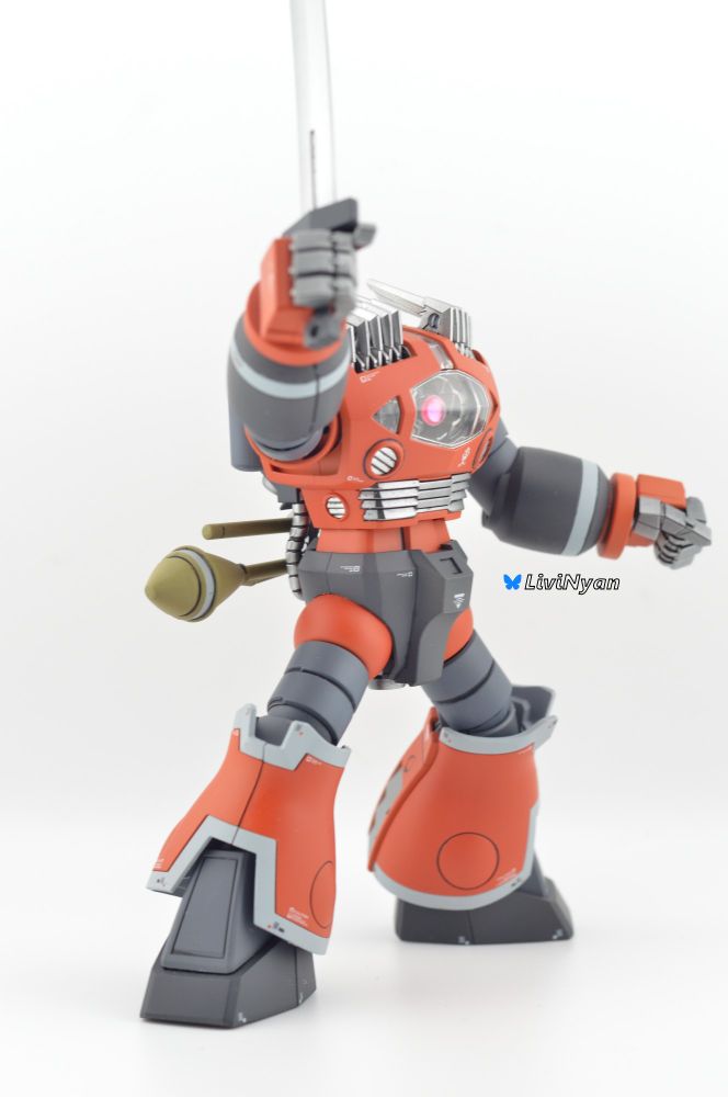 A Front On Image of a painted High Grade MSM-08 Zogok  holding its sword up to the air with one hand
