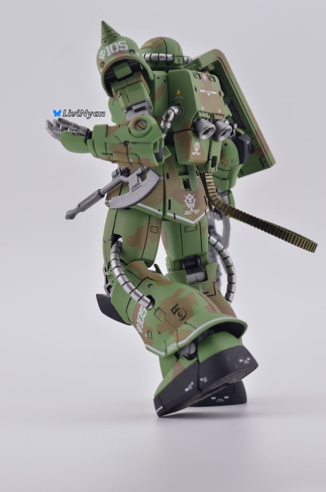 a rear picture of a Camo panted model kit of The Ms-06c zaku 2 from gundam the origin.