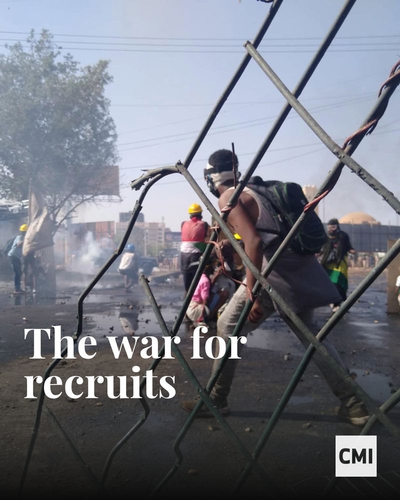 The War for Recruits. A masked young man crosses a dangerous street as others crouch for cover.