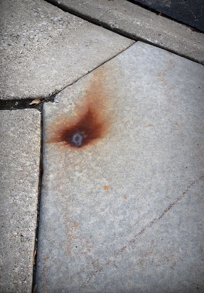 photo of a rust stain on the sidewalk