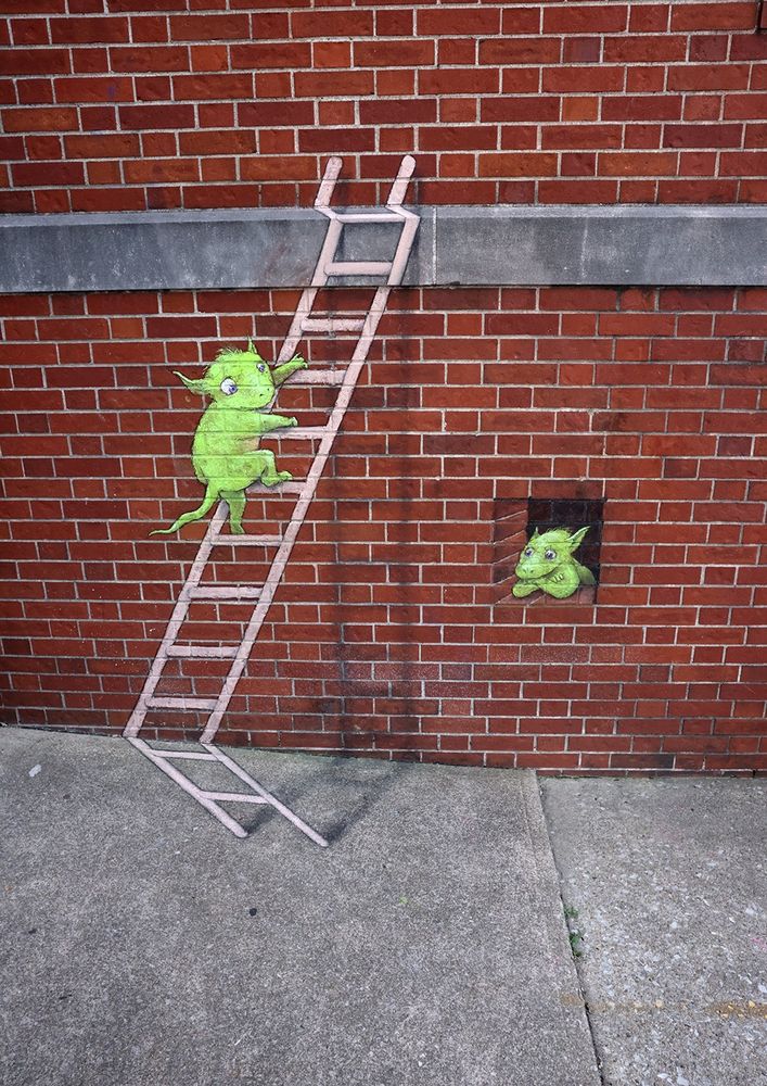 sidewalk chalk drawing of a small green monster climbing a ladder next to window where another green monster is sitting disconsolately (seen from the wrong angle for the 3D illusion to work)