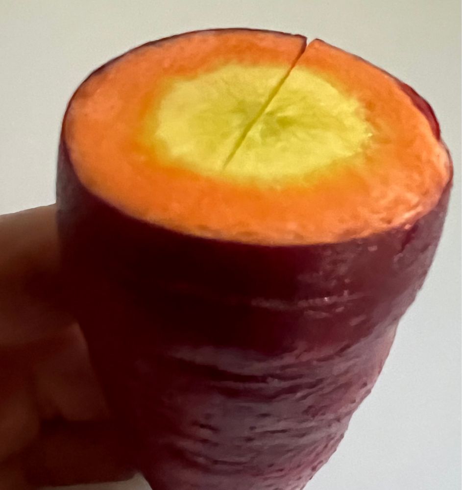 A purple carrot with an orange and yellow center.