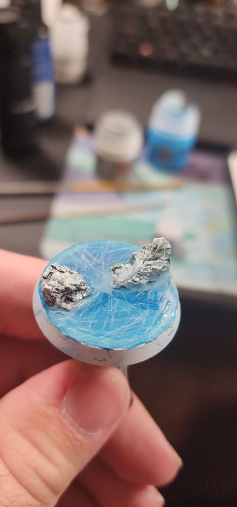 A close-up photo of the bass, sans space marine, showing the rocks coming out of the UV ice. The ice is scratched up and in some cases not so clear just to imply where to the ice