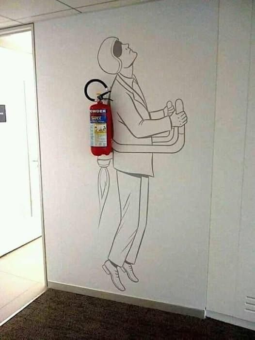 A man drawn on a wall around a real fire extinguisher to make it look like he’s using it as a jetpack. 