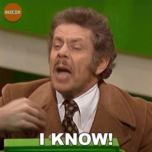 a man in a brown suit and tie says " i know "