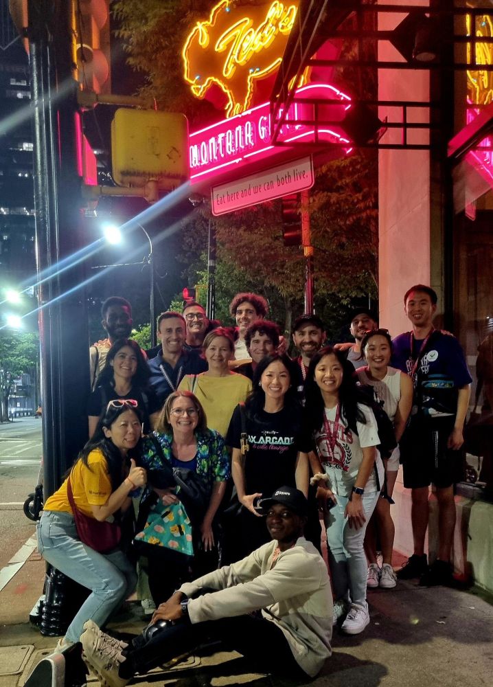 16 women and men in the street of Atlanta GA next to a restaraunt
