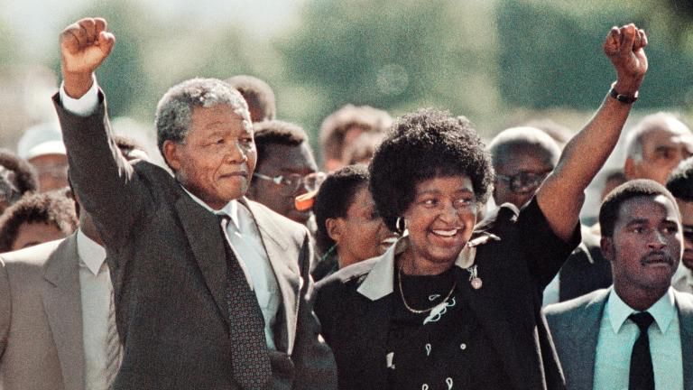 Pictured: Nelson Mandela and wife Winnie raising fists upon his release from Victor Verster prison on 11 February 1990 after 27 years of incarceration. 