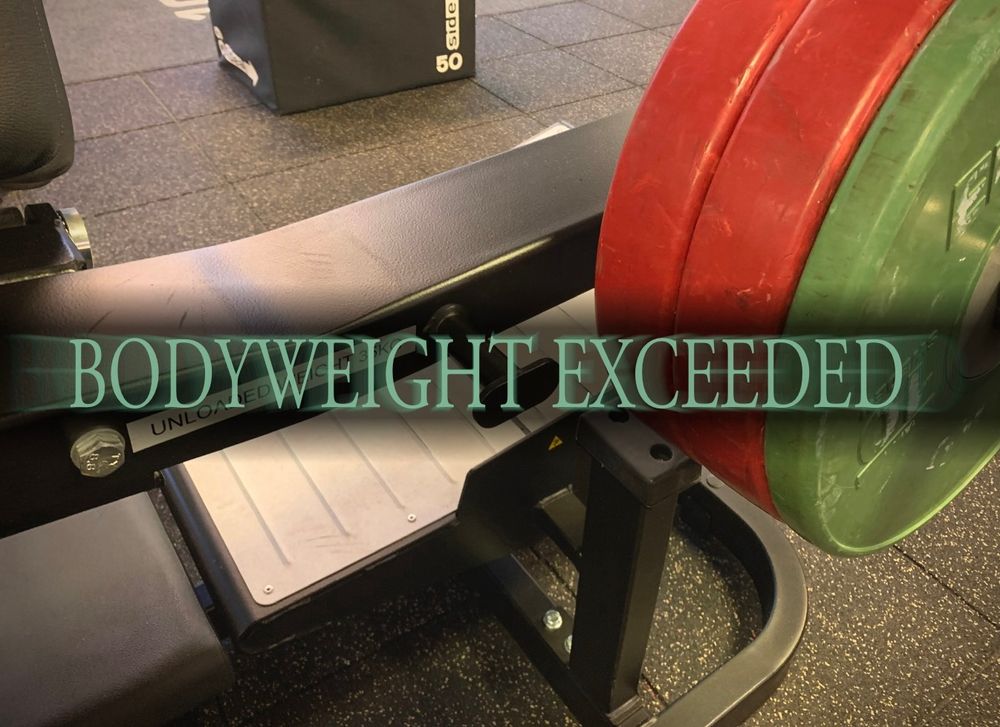 hip thrust machine loaded to 95kg with 'BODYWEIGHT EXCEEDED' in the dark souls HUMANITY RESTORED font