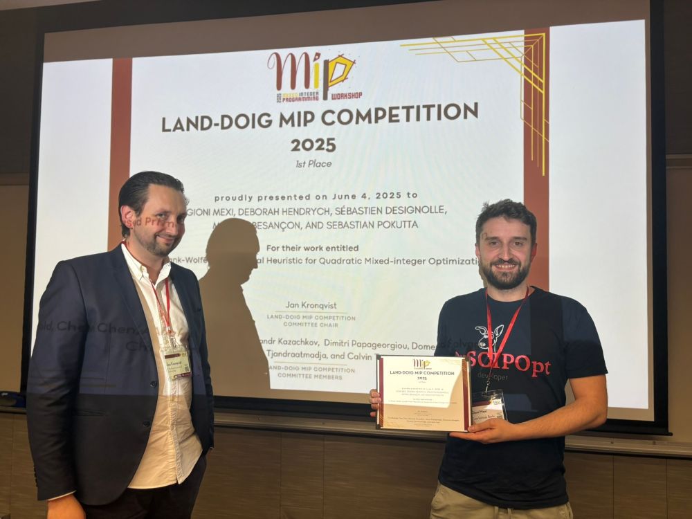 Gioni Mexi, Deborah Hendrych, Sébastien Designolle, Mathieu Besançon, and Sebastian Pokutta were awarded the Land-Doig Competition Prize 2025 at the Mixed-Integer Programming Workshop 2025 for the best contribution to the heuristic solution of Mixed-Integer Quadratic Optimization Problems (MIQP and MIQCQP).

The competition focused on the development of innovative primal heuristics that can quickly generate high-quality feasible solutions. The awarded contribution extended Boscia.jl - developed at the Zuse Institute Berlin - with novel Frank-Wolfe-based large neighborhood search heuristics, as well as gradient- and decomposition-based heuristics, specifically designed for quadratic optimization problems.

The method found feasible solutions for 88 out of 95 benchmark instances, on average in just 12.8 seconds, and achieved a mean optimality gap of 5.1%. In addition, it improved eight best-known solutions in the QPLIB benchmark library.

The photo shows, from left to right: Jan Kronqvist, Assistant Professor at KTH Royal Institute of Technology in Stockholm and member of the competition's organizing team, and Gioni Mexi.