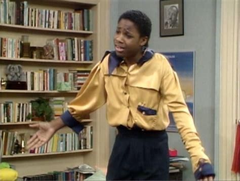 Theo Huxtable (Malcolm Jamal Warner) wearing a shirt with mismatched sleeves, an unaligned collar that is too large for him.
