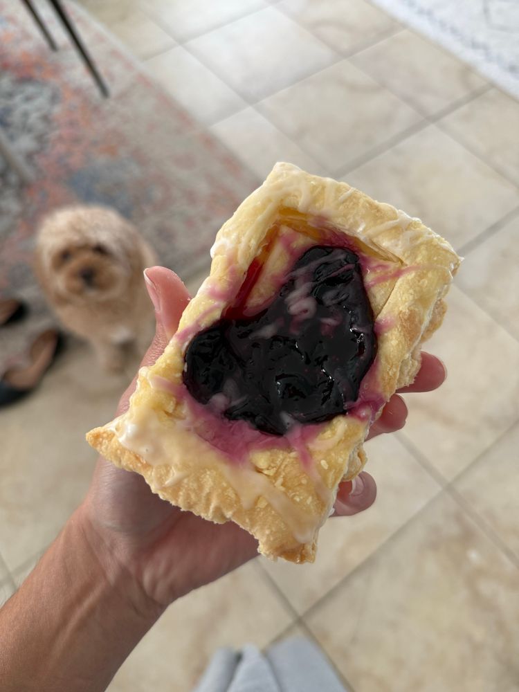 Blueberry puff pastry, with vanilla glaze

I took some blueberries from the freezer, turbinado sugar, lemon juice, and simmered it all together in a sauce pan on the stove top. Then to dropped in a cornstarch slurry, turned up the heat to medium, and stirred until it thickened into a jam.

I dropped a ladle full of the jam in the center of some scored puff pastry, and baked.

When it was done, I topped with a glaze of water, powdered sugar, and vanilla extract. 