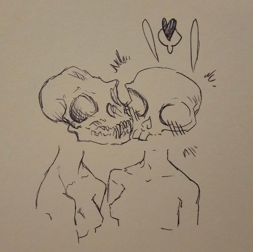 One woman smooches, another on the cheek.Their heads are animal skulls 