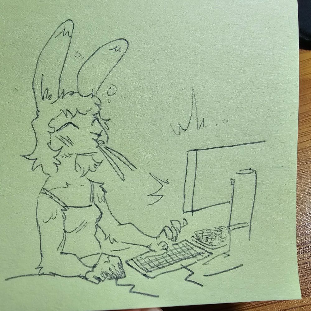 Bunny girl sits at desk playing computer, sushi piece with chopsticks stuck in her mouth