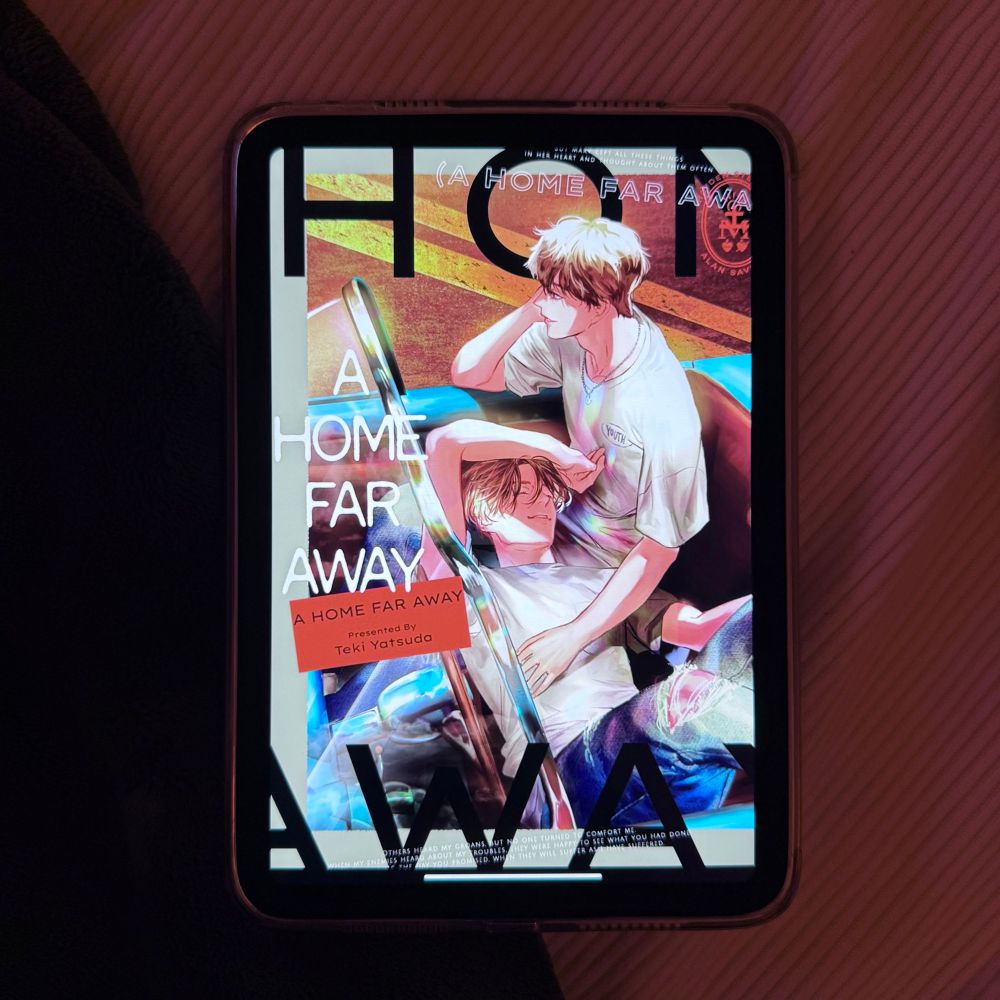 A picture of a screen with a digital copy of the BL manga A Home Far Away on display that I checked out through my library system. 