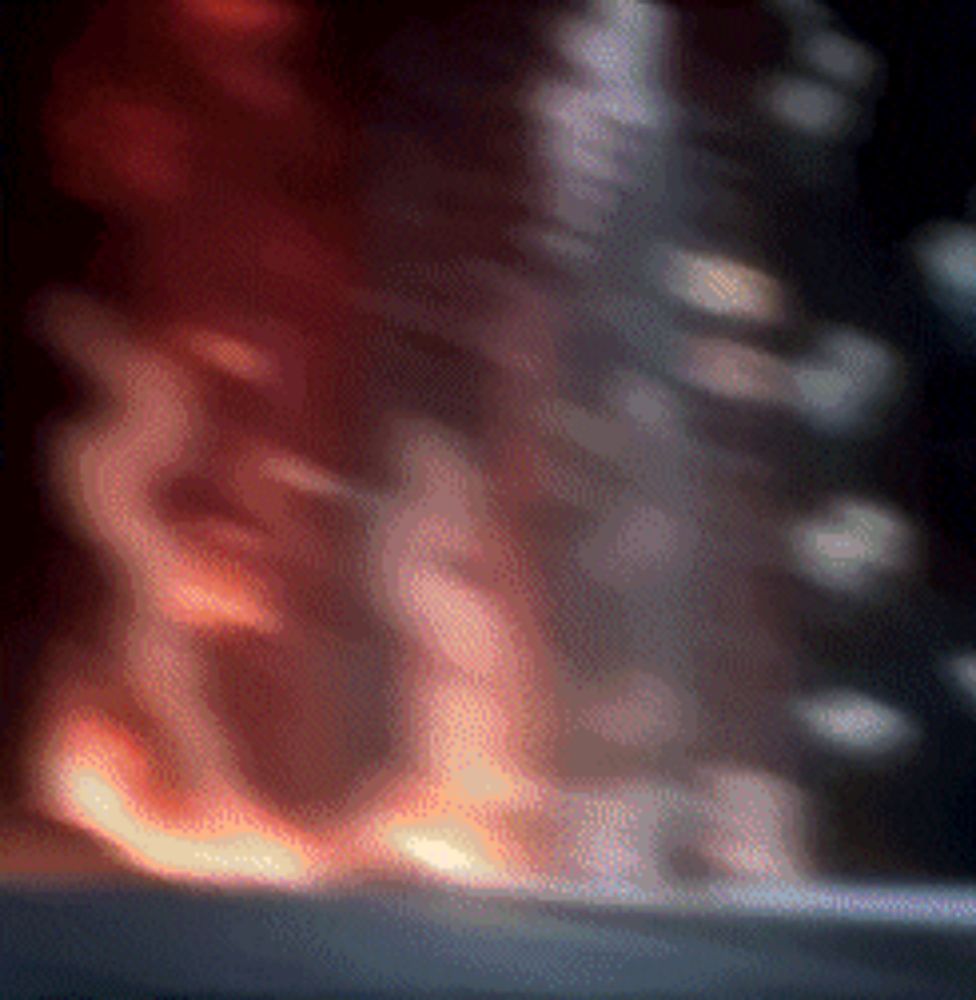 a blurry picture of a fire coming out of a building .