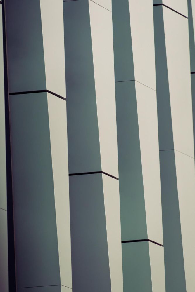 Vertically oriented image of four columns that taper in size from top to bottom with staggered vertical gaps.