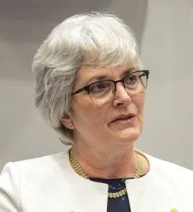 A headshot of Dr Crystal Oldman who has short grey hair and glasses.