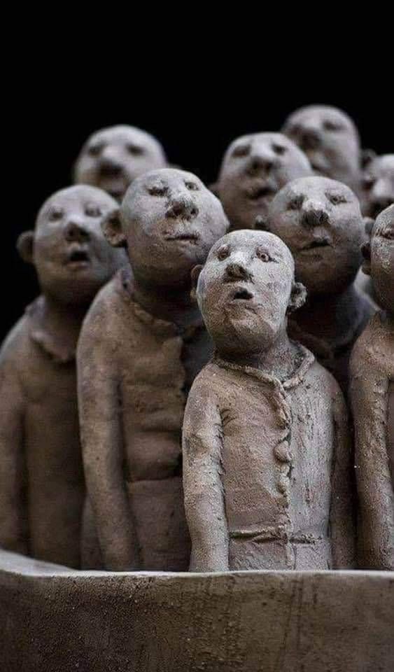 Statues of a bunch of dopey-looking bald guys looking in different directions with their mouths open.