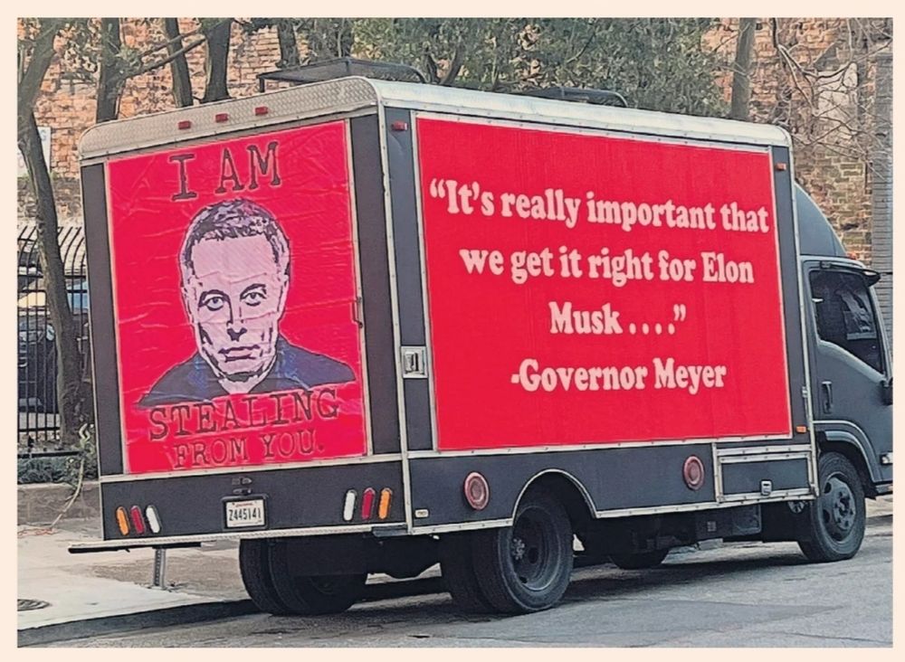 A photo of a small cargo truck painted red with a picture of Musk that says "I am stealing from you." 