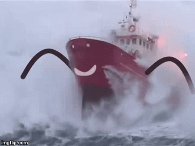 a red boat with a smiley face on the side is floating in the ocean .