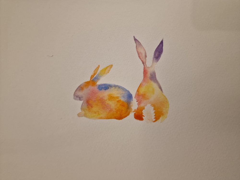 Two watercolour bunnies in rainbow colours