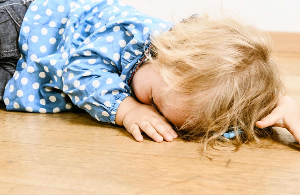 Toddler sleeping on the floor. 