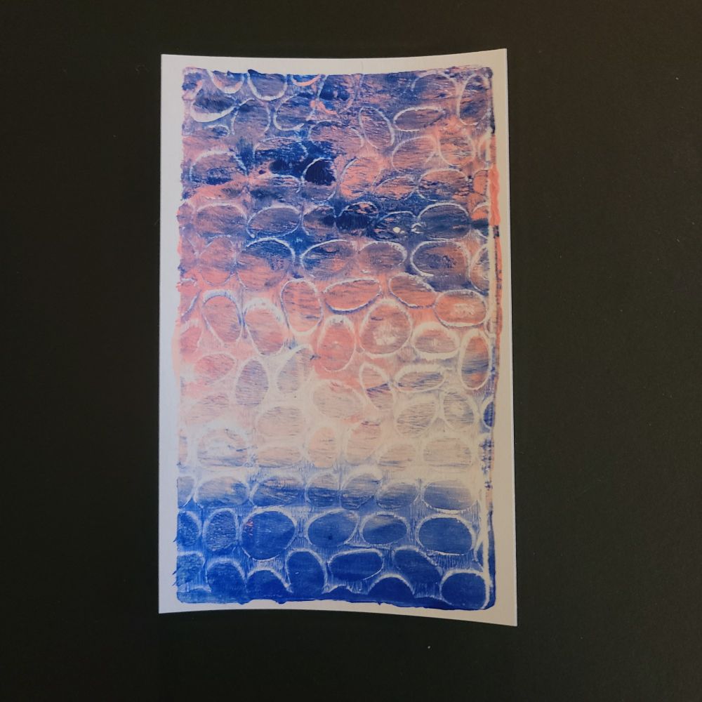 Gelli plate print in blues and pinks with texture