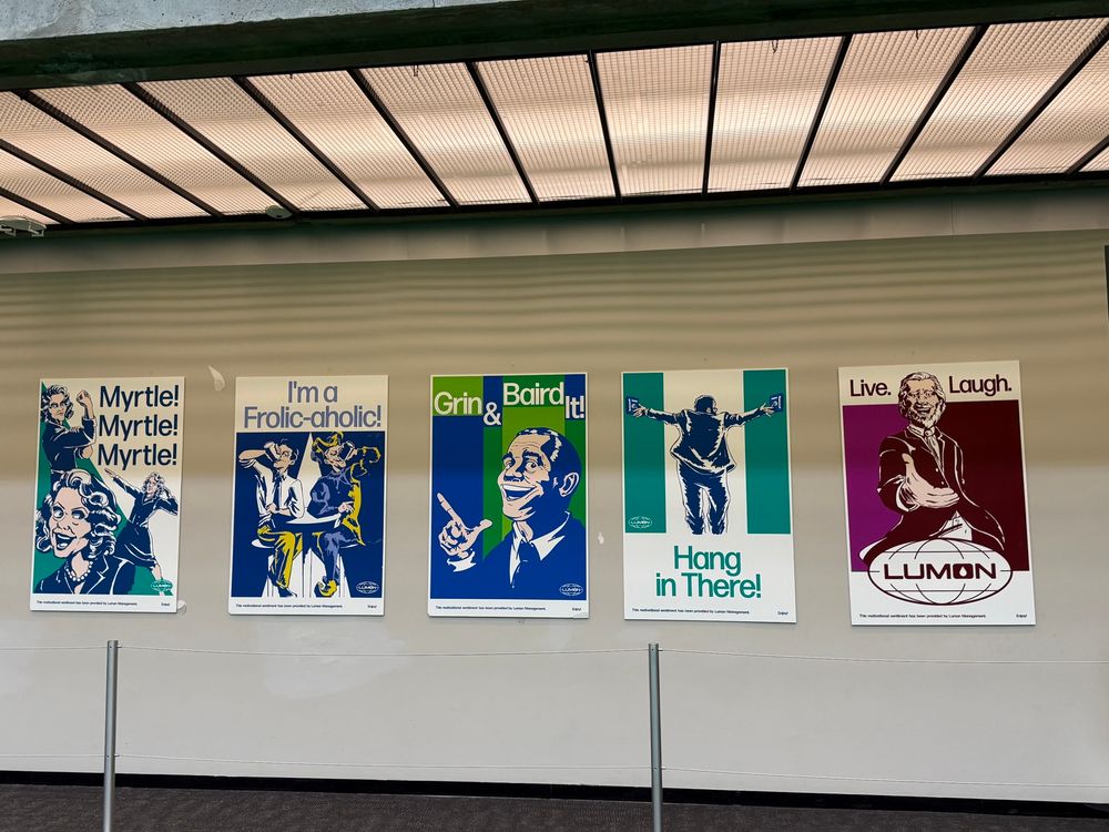 numerous posters of Lumon propaganda from Severance 