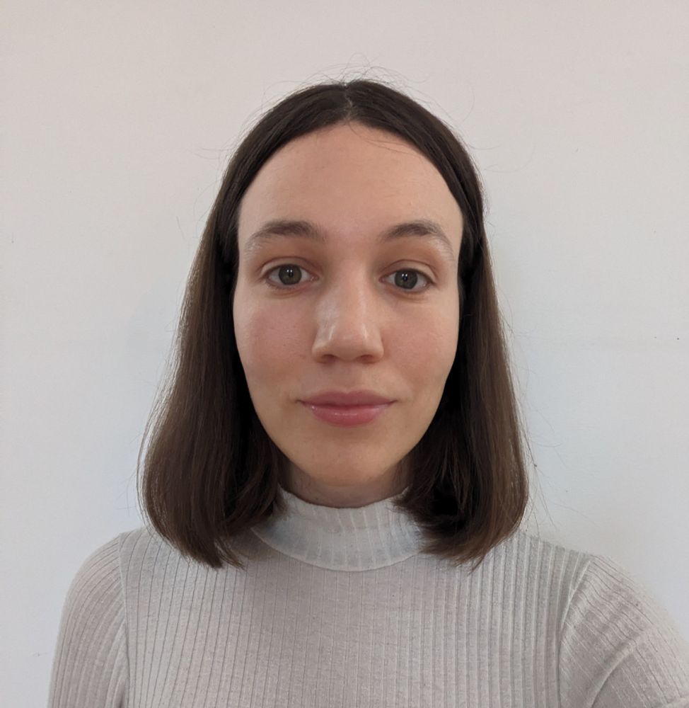 A photo of Catriona who has a shoulder length bob and a gentle smile. She is wearing a white polo neck as she looks directly into the camera