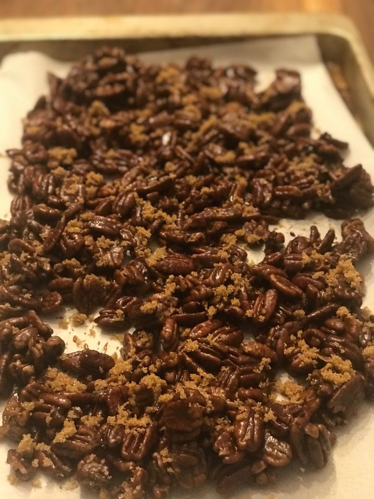 A tray of candied pecans sprinkled in brown sugar