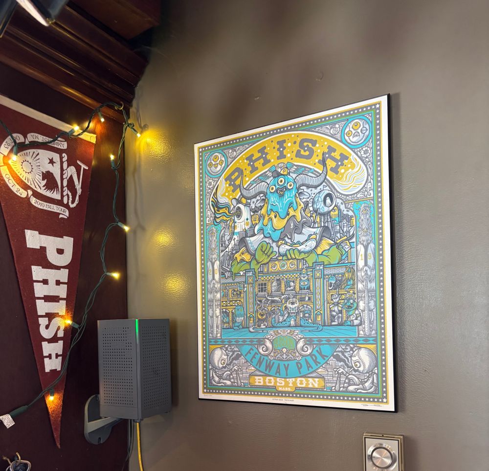 Phish concert poster from Fenway Park and a Phish banner. Both hanging in a restaurant in Maine 