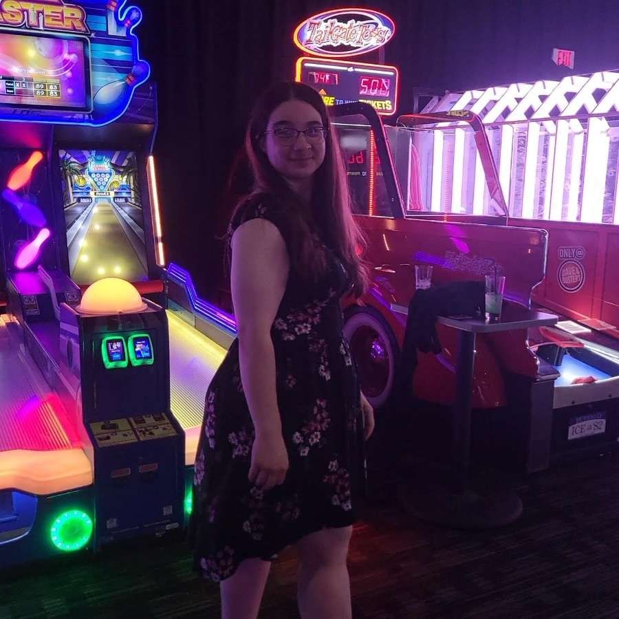 Me posing by a ski ball game