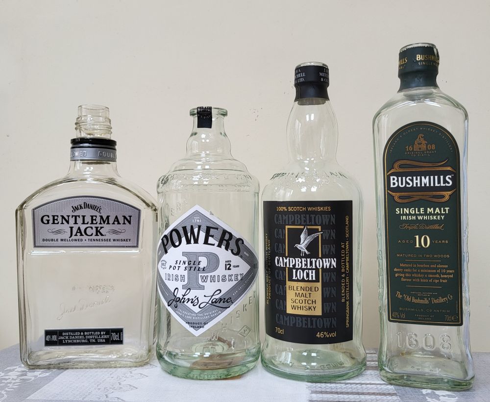 4 empty whisk(e)y bottles.