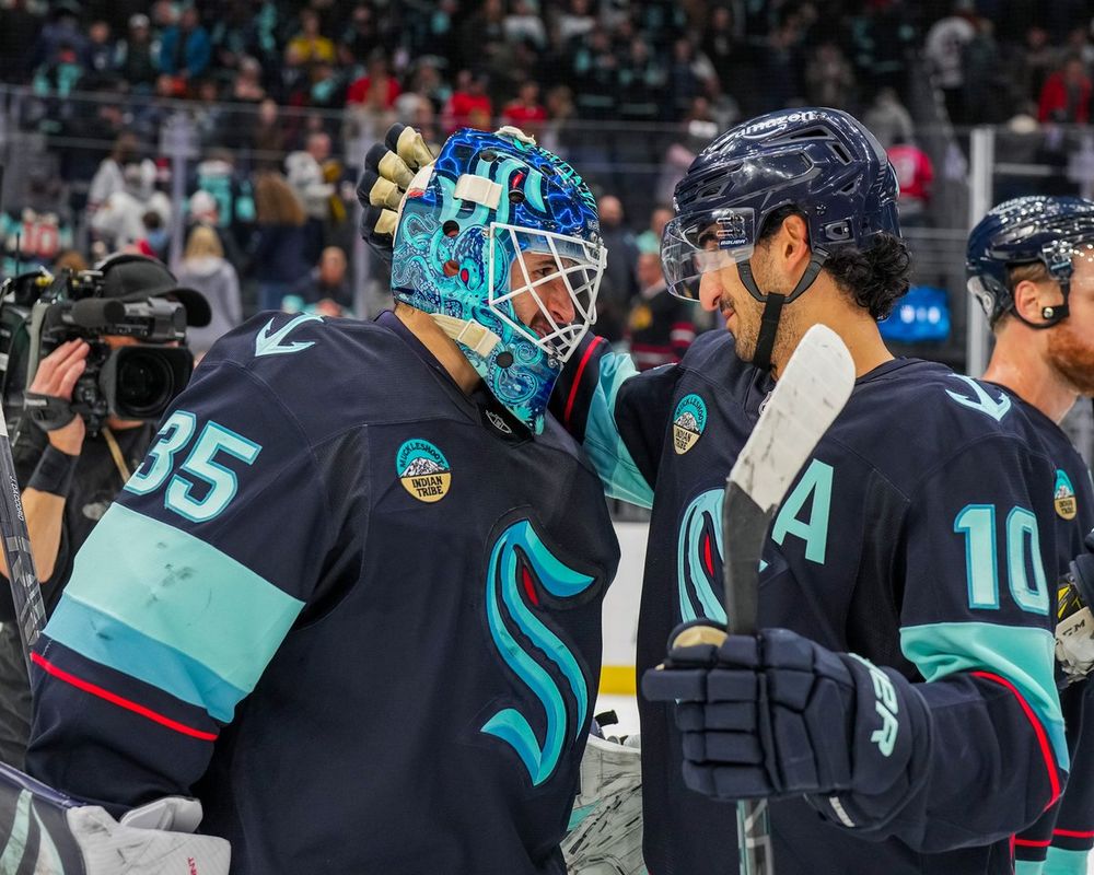 Photo of Joey and Matty smiling while looking at each other before a hug.