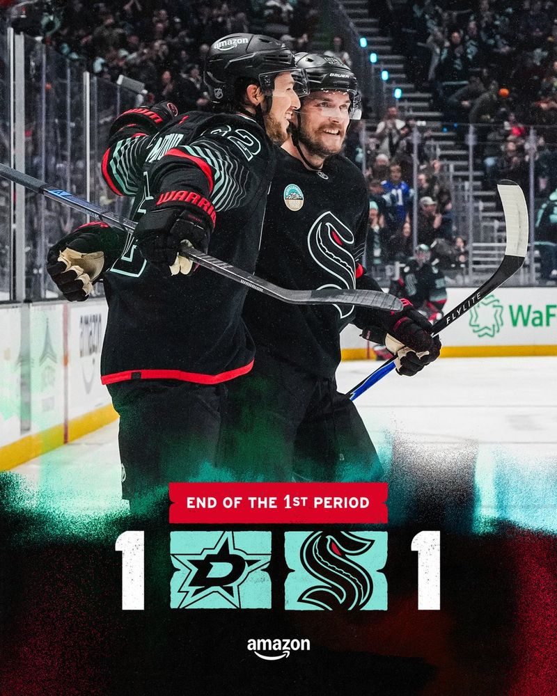 End of 1st period graphic with a black background. The arena coordinates and an Amazon logo are along the top of the graphic in white lettering. An image of game action, featuring a photo of Brandon Montour and Ryan Lindgren celebrating Montour’s goal, overlayed in the center of the graphic. The Stars logo, Kraken logo and score are along the bottom of the graphic. The score is 1-1.