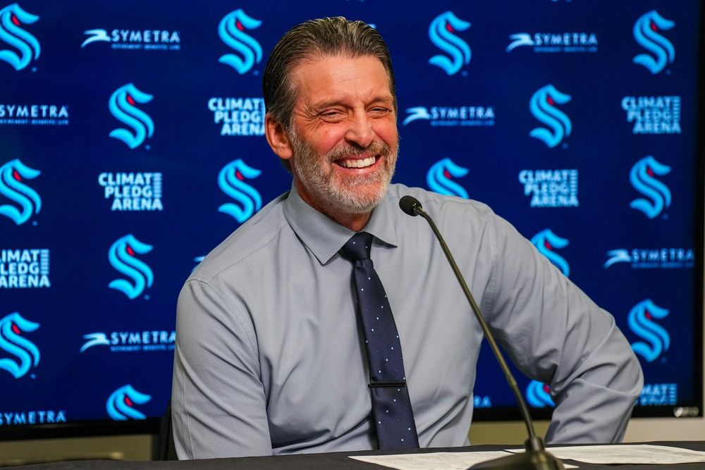 Photo of Coach Lambert smiling during a press conference.