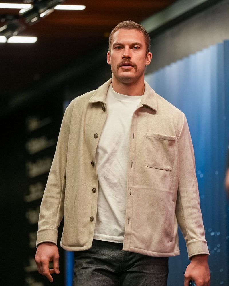 a photo of Seattle Kraken defenseman Jamie Oleksiak walking into today's game wearing a cream-colored jacket.