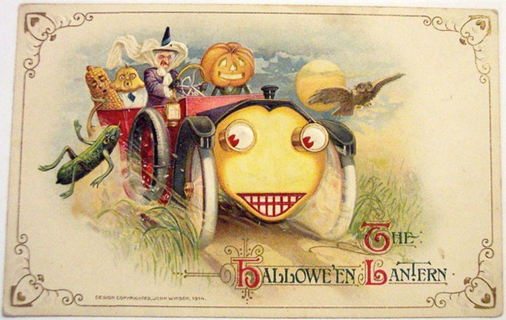 A post card depicting an old fashioned motor car with a face a witch is driving with a pumpking head beling next to her, then there is a pickle gerkin with arms and legs falling out of the car whilst other food try to grab it. An owl is flying in front of the moon to the left. 
Image by John Winslow, Public domain, via Wikimedia Commons 