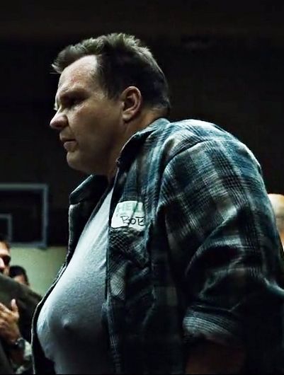 Bob from Fight Club .He is a larger man with big boobs and a flat military style haircut.