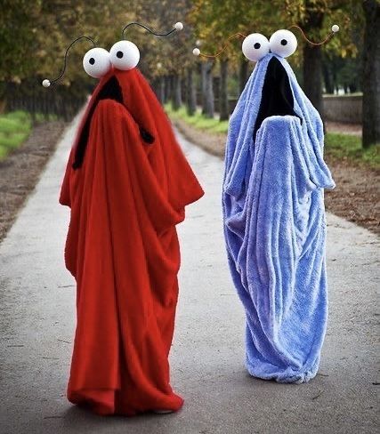the meep-meep guys, costumed, adult-sized, strolling down a path 