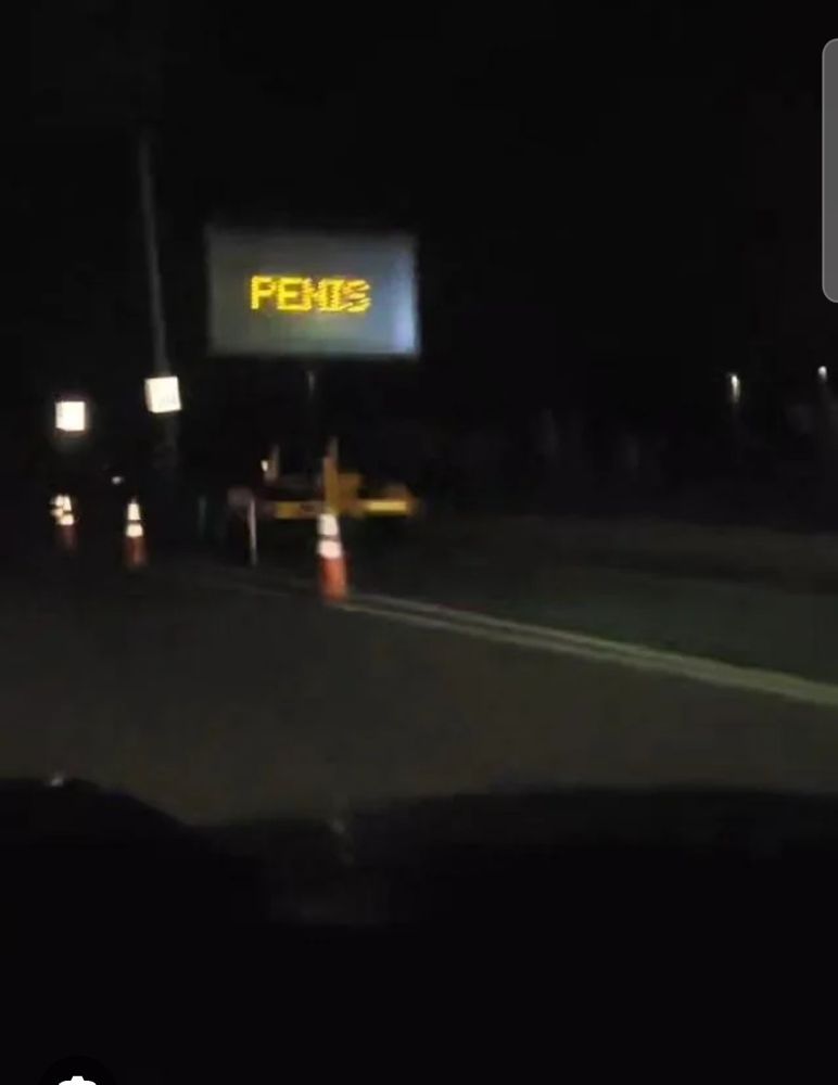 a digital road sign hacked to say PENIS 