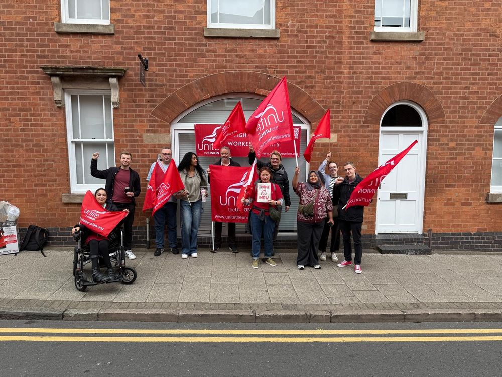 Unite NEU members with red Unite Flags on a picket outside the NEU West Mids office