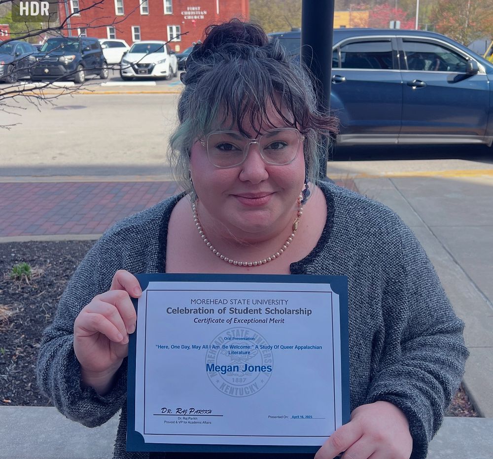MJ holding her award for a Certificate of Exceptional Merit