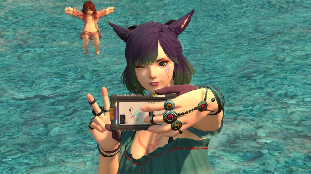 Xina taking a selfie in front of the water on the beach in Tuliyollal. Shinono is behind her trying to stay afloat.